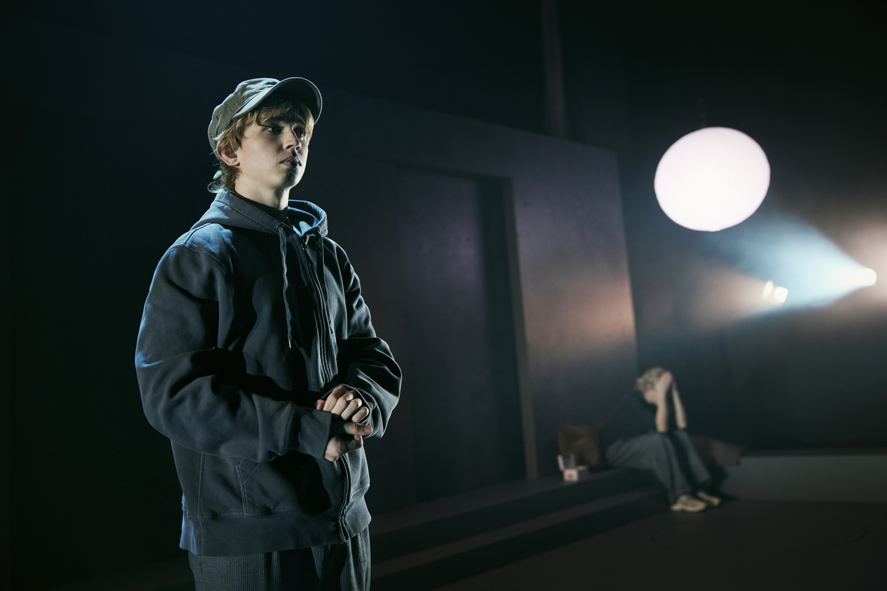 Dreng i gråt tøj med kasket i musicalen Next to Normal på Odense Teater